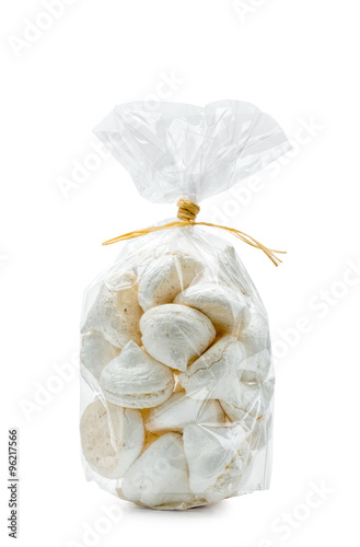 French white meringues in a cellophane bag, isolated on white background