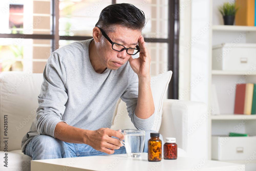 asian senior with severe headache and medicine asian senior with severe headache and medicine
