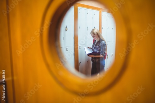 Standing student studying seen trough the window