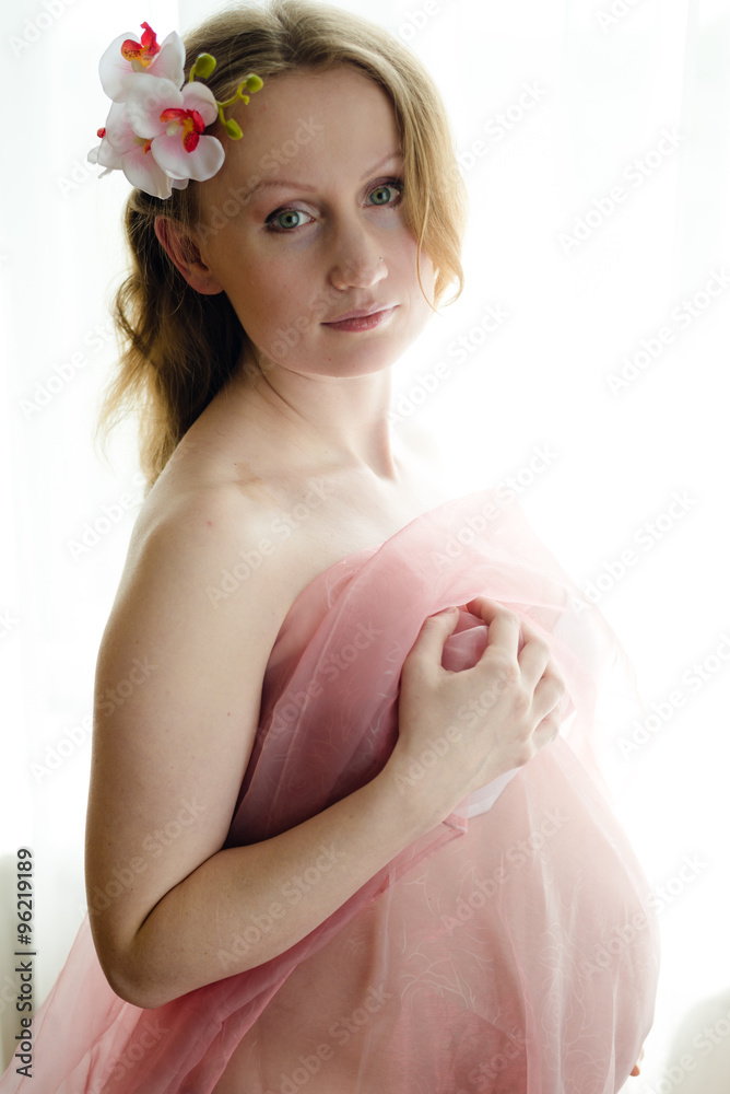 Pregnant beautiful young woman on light copy space background, closeup picture Pregnant beautiful young woman on light copy space background, closeup picture