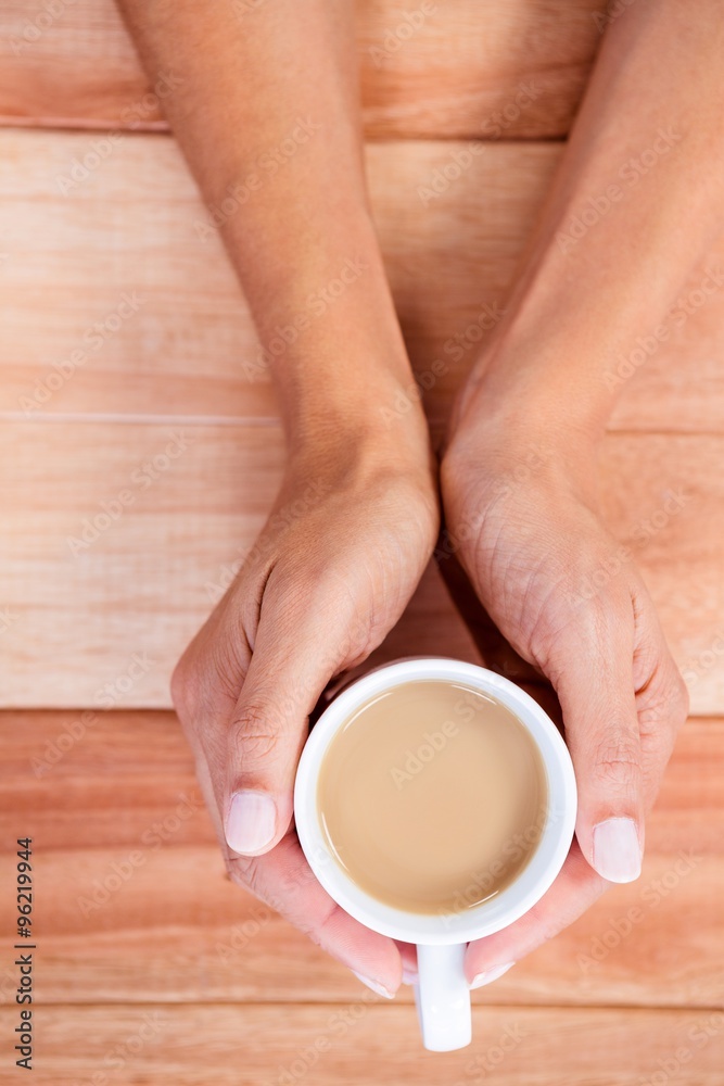 Womans hands holding cup of coffee Womans hands holding cup of coffee