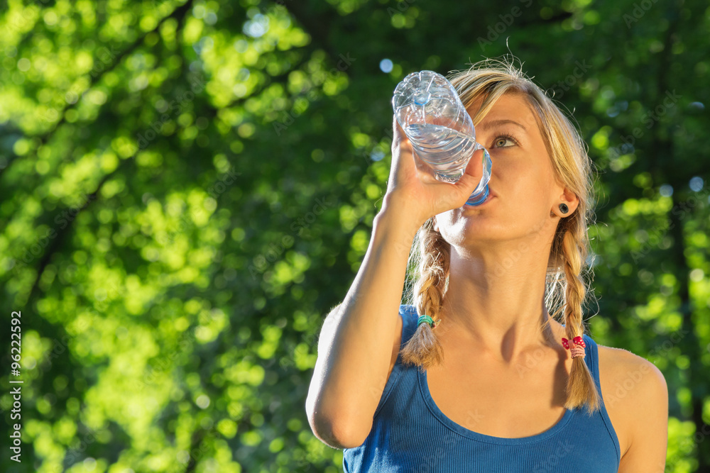 Jogger drinking water after hard exercise. Jogger drinking water after hard exercise.