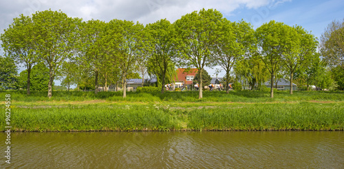 Cyclists riding along a canal in spring
 photo