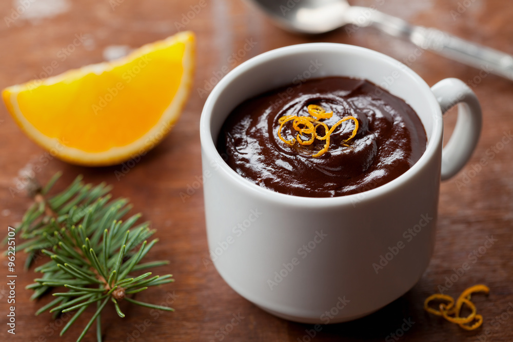 Delicious dessert from dark chocolate mousse with orange slice decorated citrus peel on rustic table Delicious dessert from dark chocolate mousse with orange slice decorated citrus peel on rustic table