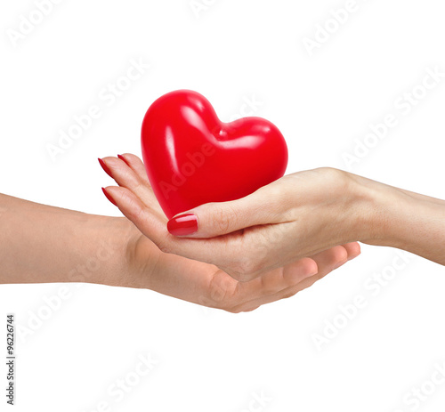 Red heart in woman and man hands  isolated on white