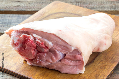 Canvas Print Raw pork knuckle on a cutting board