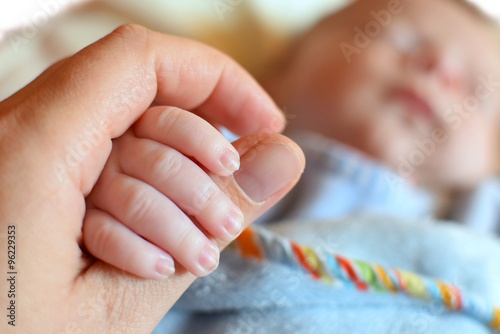 Holding the hand of a baby