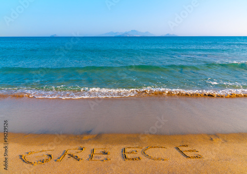 the name of GREECE written on the sand of Kardamaina beach at Kos island in Greece photo