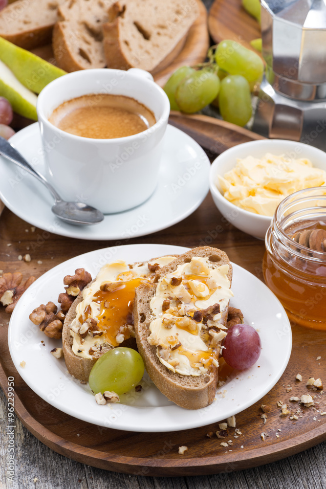 bread with butter, honey, nuts and grapes for breakfast