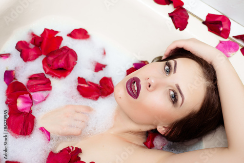 Picture of elegant sexy pretty girl with silk skin having fun laying in water bath relaxing on copy space