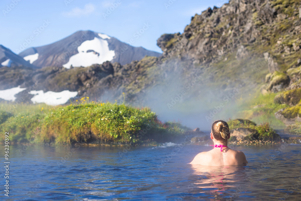 Fototapeta premium Young woman relax hot spring in Iceland Landmannalaugar