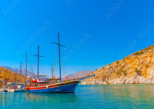 traditional wooden big sailing boat  docked at the port of Vathi village in Kalymnos island in Greece