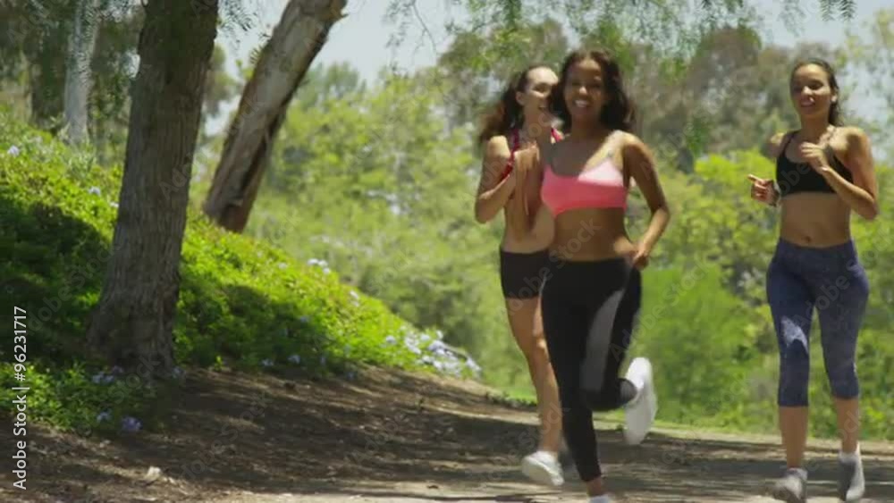 Happy women running together at the park Happy women running together at the park
