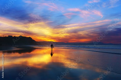 man walking on the beach at sunset © mimadeo