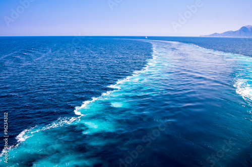 The wake of a boat as seen from the stern of a ship on Mediterranean sea