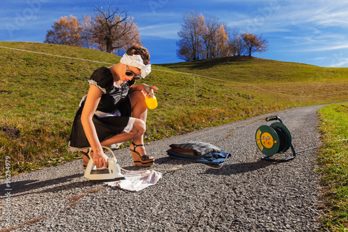 Scene housewife who irons in the road photo