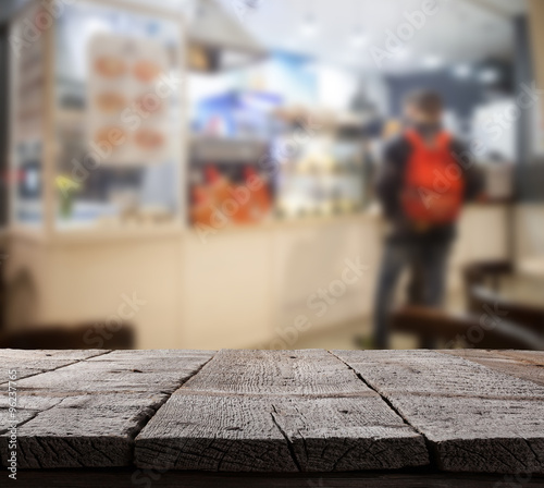Coffee shop blurred background with bokeh and wooden floor
