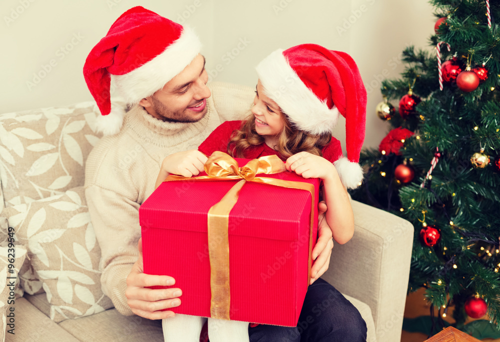 smiling father and daughter opening gift box smiling father and daughter opening gift box