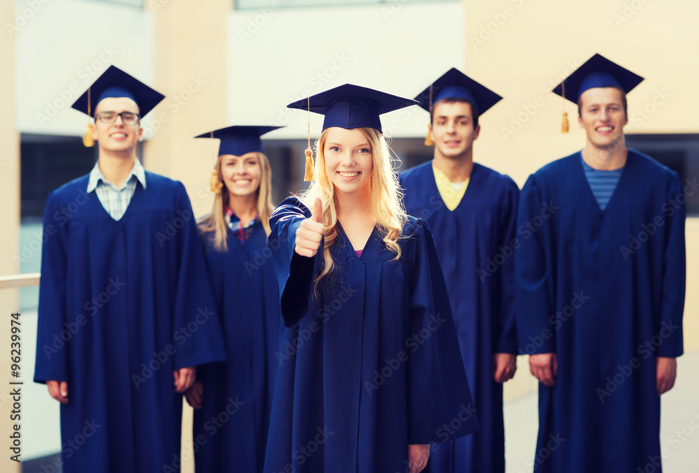 group of smiling students in mortarboards group of smiling students in mortarboards