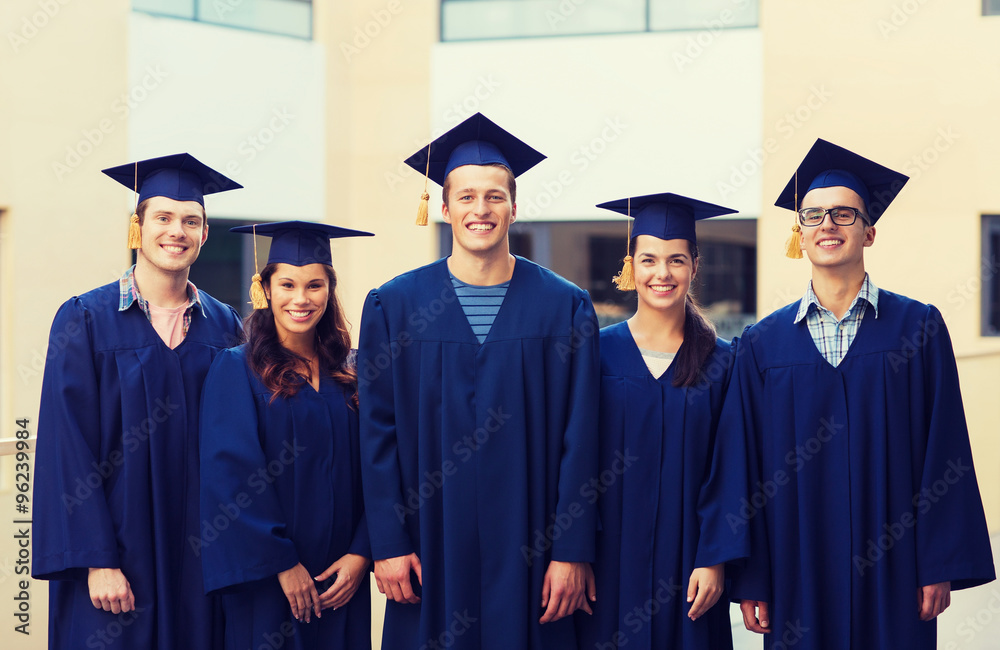 group of smiling students in mortarboards group of smiling students in mortarboards