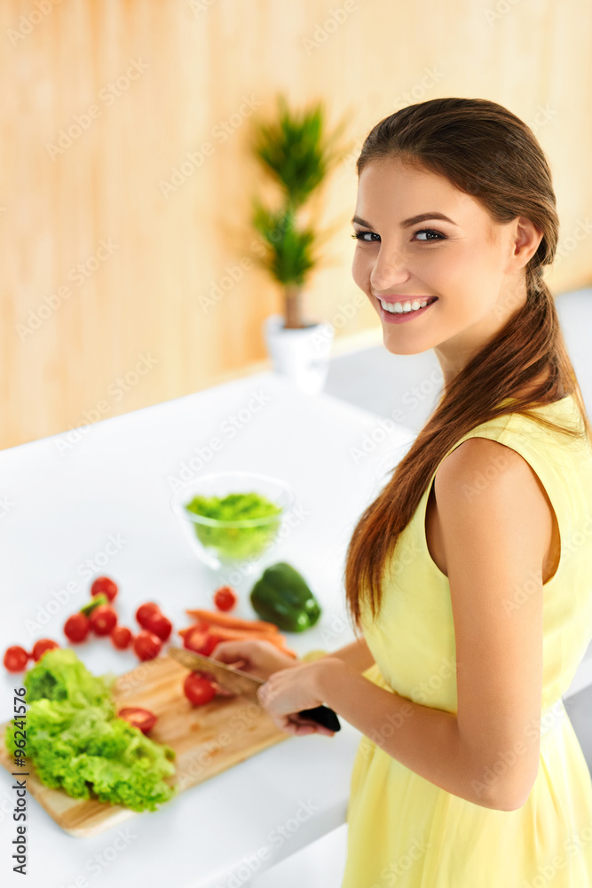 Healthy Food. Happy Smiling Young Woman Preparing Vegetarian Dinner, Cutting Vegetables, Cooking Salad With Knife In Kitchen. Healthy Lifestyle And Eating. Diet, Dieting Concept. Nutrition