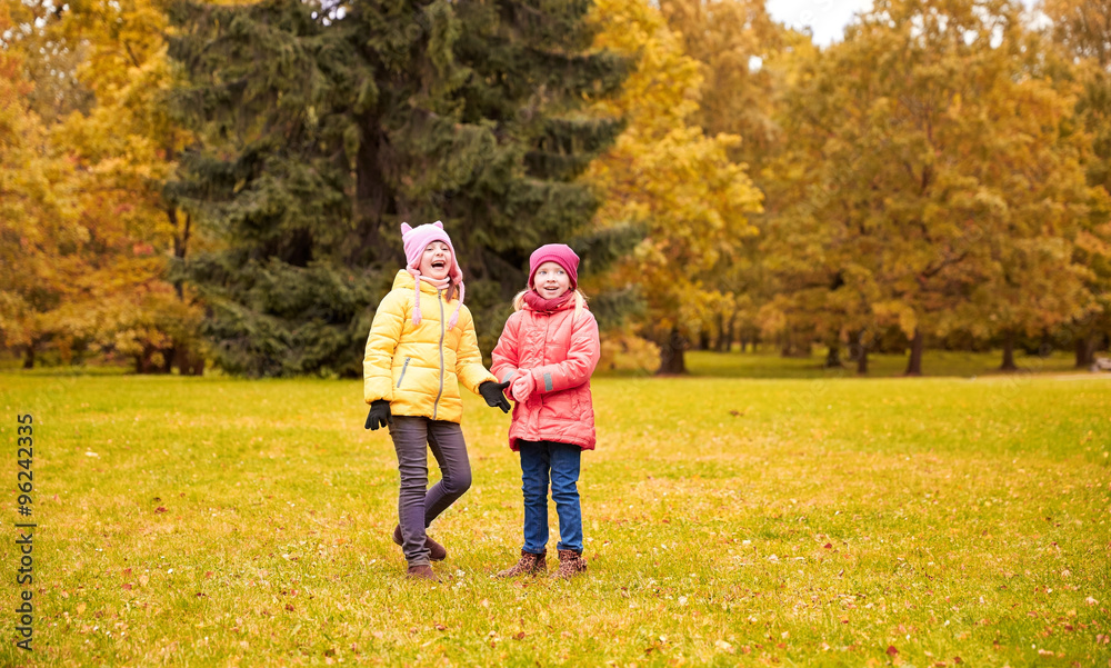 Fototapeta premium two happy little girls in autumn park