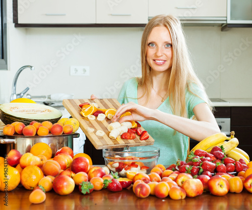   long-haired woman cooking fruit salad