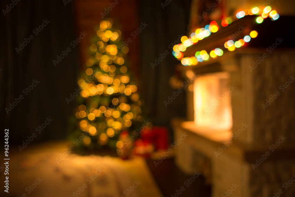 Blurred living room with fireplace and decorated Christmas tree