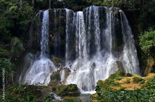 Waterfall in a lush rainforest. Beautiful waterfalls or cascades in El Nicho, El Nicho waterfall, in Scambray mountains. Cienfuegos province, Cuba.