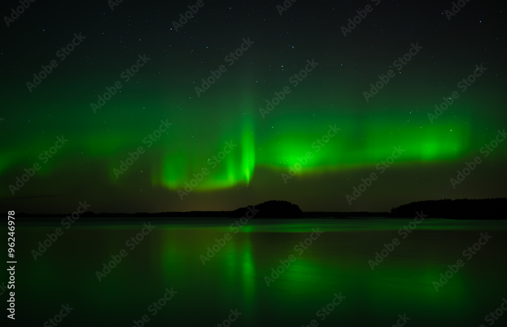 Fototapeta premium Northern lights over calm lake in Sweden (Aurora borealis)