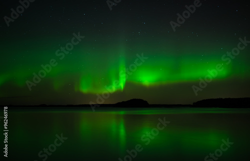 Northern lights over calm lake in Sweden (Aurora borealis)
