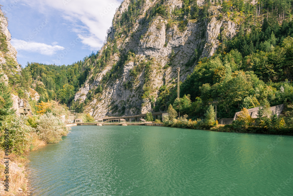 Embankment dam in the water gap from the Enns river in Gesaeuse mountain range and view into the Enns valley. The Gesaeuse range is part of the Ennstal Alps and a national park in Styria, Austria