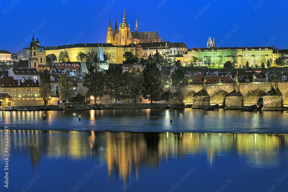 Prague, Czech Republic. Evening view of the Prague Castle with St. Vitus Cathedral, Castle district, Mala Strana district with St. Nicholas Church, and Charles Bridge with Mala Strana Bridge Towers.