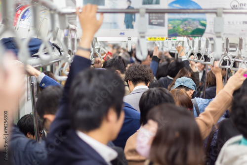 Passengers traveling by Tokyo metro.