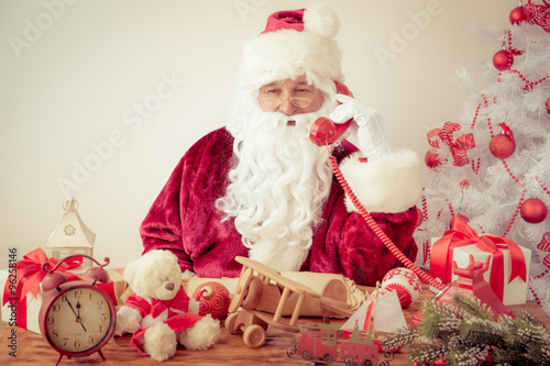 Santa Claus talking by phone © Sunny studio