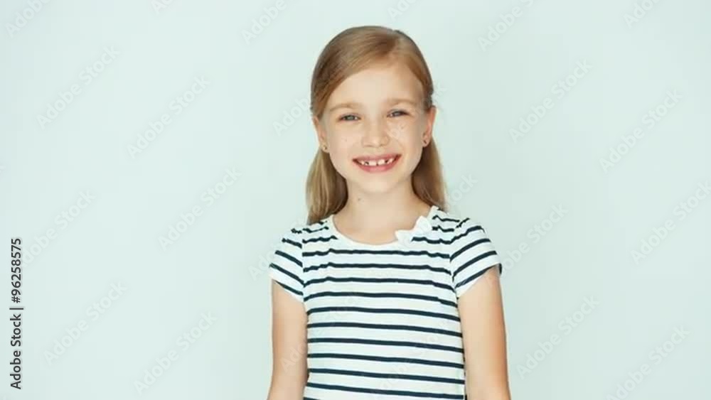 Portrait girl child turns around head and smiling at camera Portrait girl child turns around head and smiling at camera