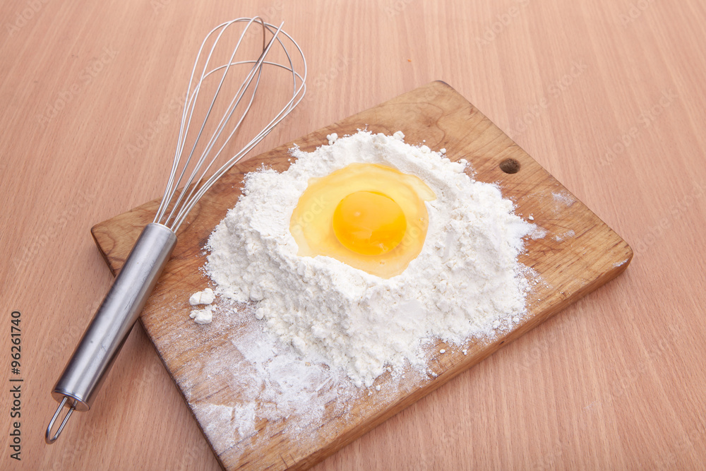 Egg white and yolk in floor on kitchen table Egg white and yolk in floor on kitchen table