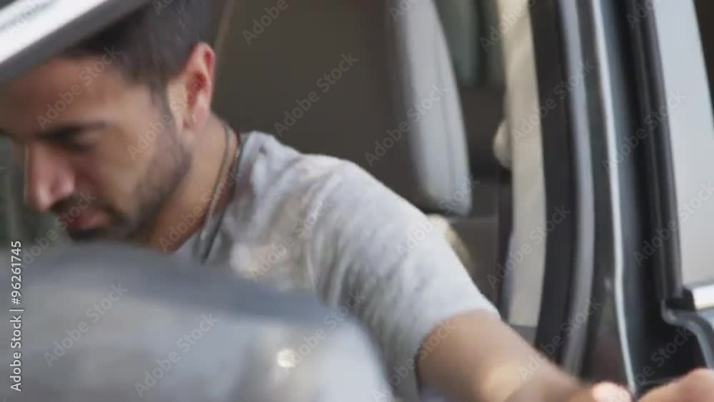 Handsome hispanic man getting into his car Handsome hispanic man getting into his car
