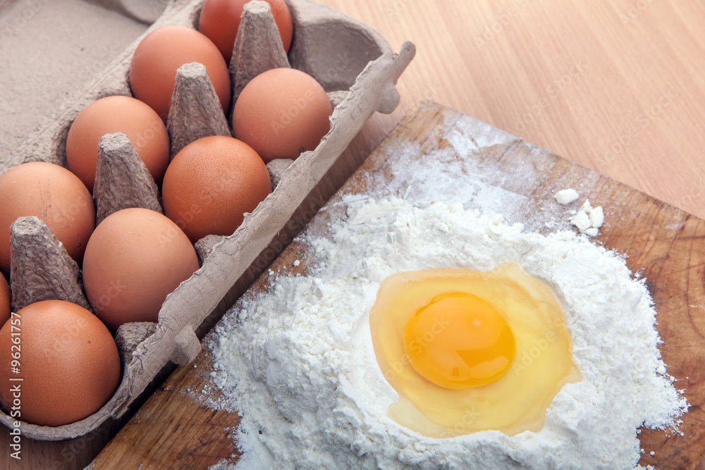 Egg white and yolk in floor on kitchen table