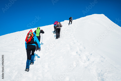 prominent group of tourists on a snowy mountain