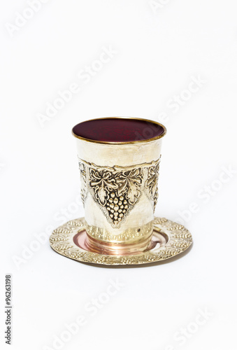 Silver cup with red wine