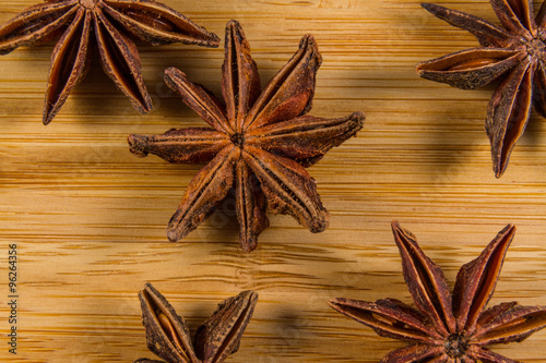 Star Anise, Illicium verum on a wood background. Close up.