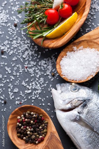 Delicious fresh fish on dark vintage background. healthy food, diet or cooking concept