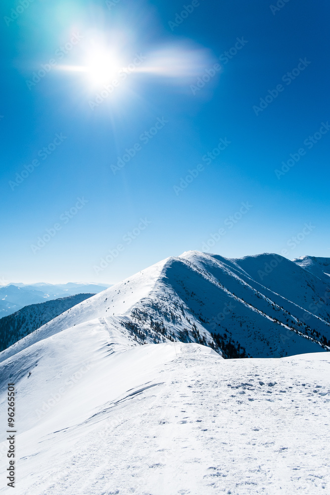 snowy mountains with the sun