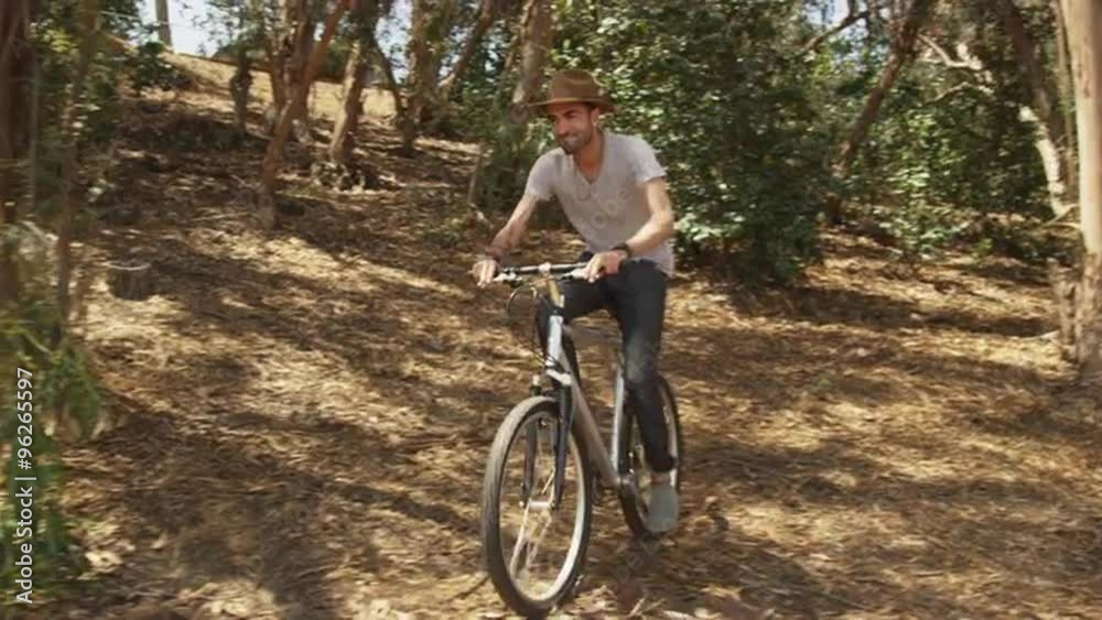 Handsome Hispanic man riding bike on trail Handsome Hispanic man riding bike on trail