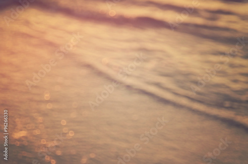 Blur beach with bokeh sun light abstract background.