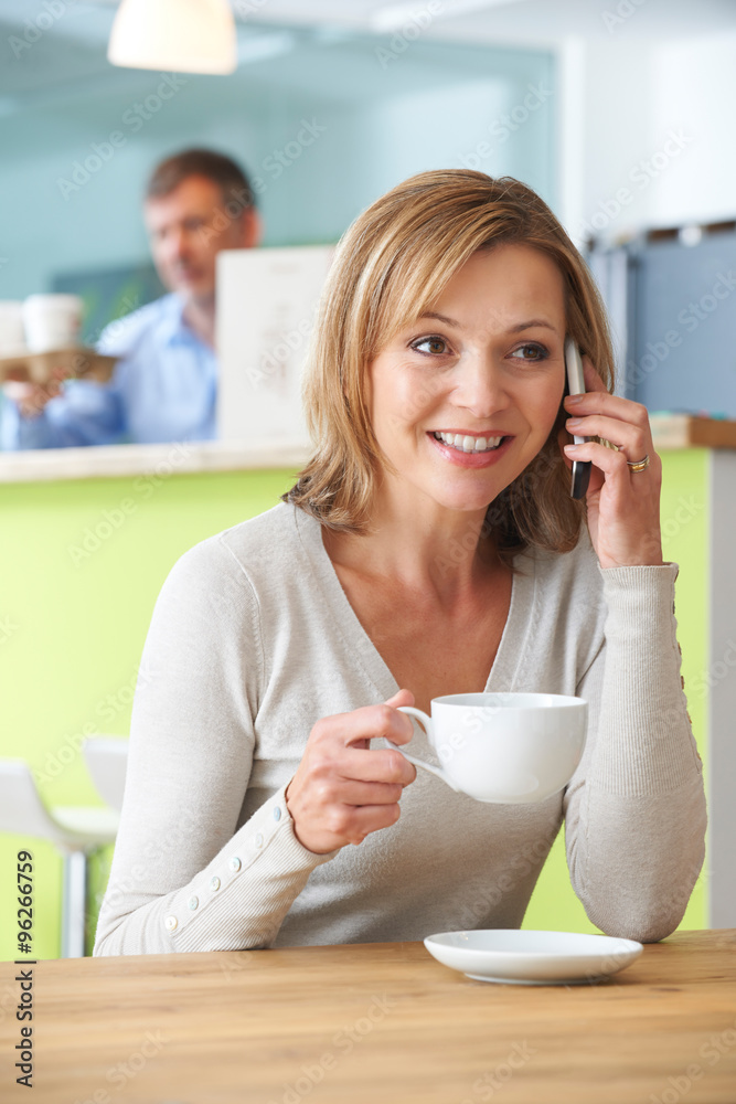 Woman Talking On Mobile Phone In Coffee Shop Woman Talking On Mobile Phone In Coffee Shop