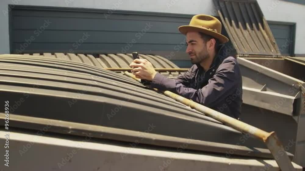 Stylish hispanic man using smartphone outdoors Stylish hispanic man using smartphone outdoors