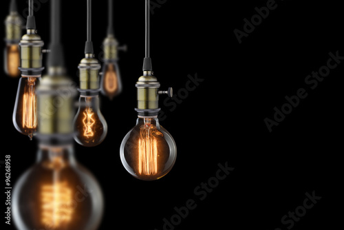 vintage glowing light bulbs on black background photo