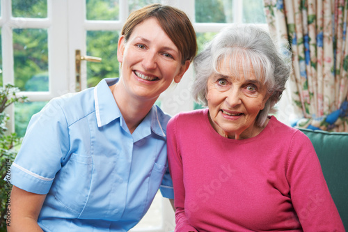 Senior Woman At Home With Carer